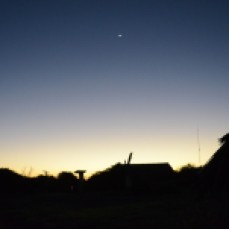 As the sun begins to set, the night sky covers the small village